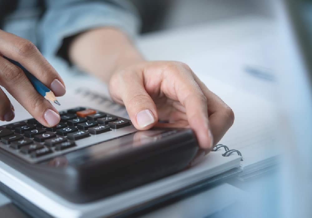 Close,Up,Woman,Hand,Using,Calculator,To,Calculate,Home,Finance