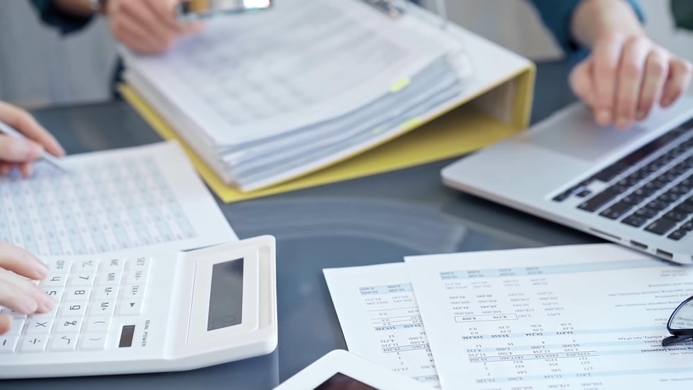Business,Colleagues,Reviewing,Financial,Documents,And,Calculating,Taxes.,Auditor,Inspecting